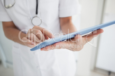 Doctor scrolling on her tablet