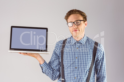 Geeky businessman showing his laptop