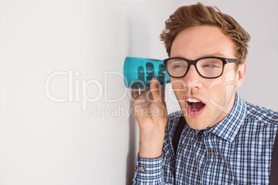 Geeky businessman eavesdropping with cup