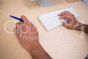 Hands using keyboard and mouse at desk