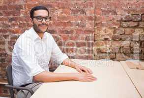 Portrait of smiling businessman sitting at desk