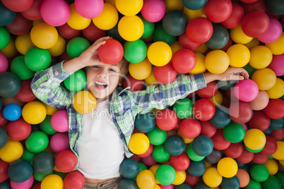 Cute boy smiling in ball pool