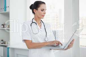Doctor using her laptop at work