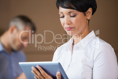 Female manager using digital tablet in warehouse