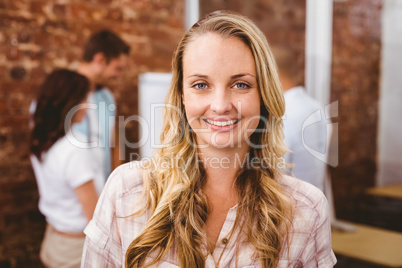 Casual businesswoman smiling at camera during meeting