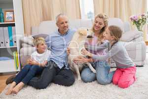 Parents and children on rug with labrador
