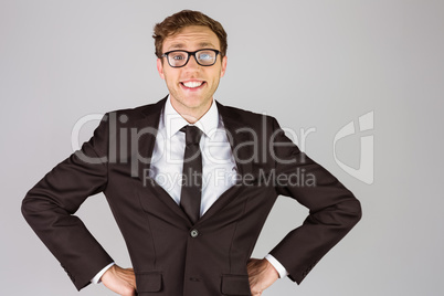 Young geeky businessman smiling at camera