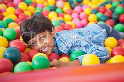 Cute boy smiling in ball pool