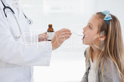 Young girl taking her medicine