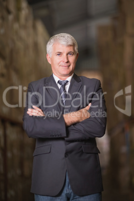 Smiling male manager with arms crossed