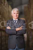 Smiling male manager with arms crossed