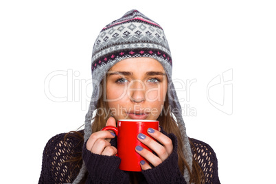 Beautiful woman in warm clothing drinking coffee
