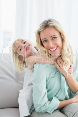 Mother sitting on the couch with her daughter