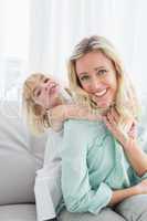 Mother sitting on the couch with her daughter