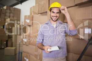 Worker with clipboard in warehouse