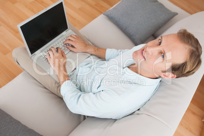 Casual man using laptop on the couch Casual man using laptop on the couch