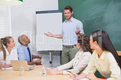 Businessman giving presentation to co workers