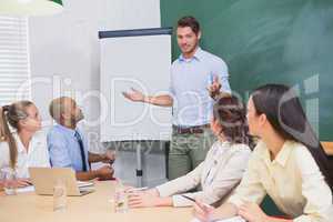 Businessman giving presentation to co workers
