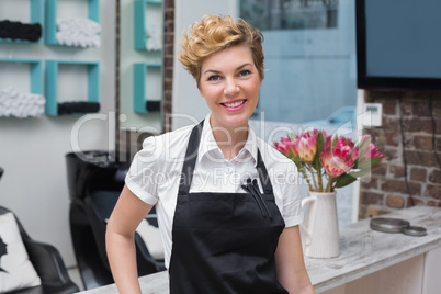 Confident hairdresser smiling at camera