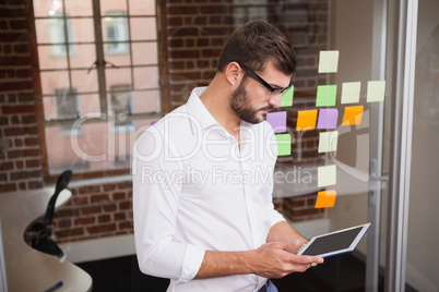 Casual businessman using his tablet