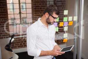 Casual businessman using his tablet