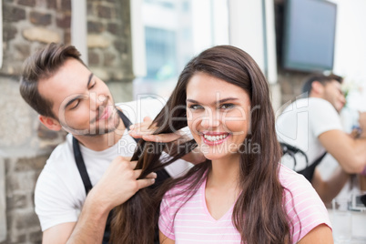 Handsome hair stylist with client