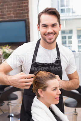 Handsome hair stylist with client