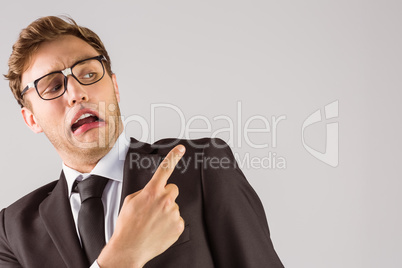 Young geeky businessman pointing to shoulder