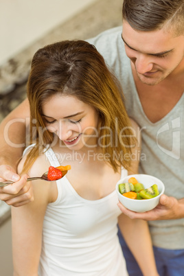 Couple eating fruit salad at breakfast