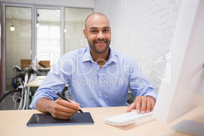 Man working at desk with computer and digitizer