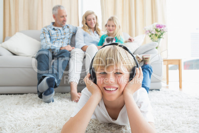 Little boy listening to music on the floor