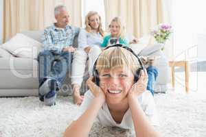 Little boy listening to music on the floor