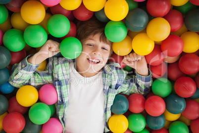 Cute boy smiling in ball pool