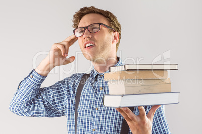 Geeky student holding a pile of books