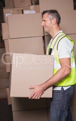 Worker with boxes in warehouse