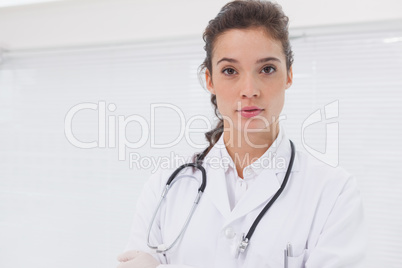 Concentrated doctor standing with stethoscope