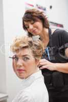 Hairdresser styling customers hair