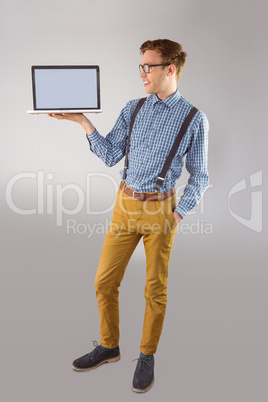 Geeky businessman showing his laptop