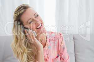 Pretty happy blonde phoning with mobile phone