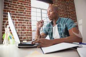 Casual businessman working at his desk