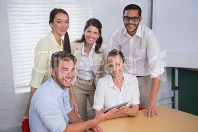 Smiling business people using digital tablet in meeting Smiling business people using digital tablet in meeting