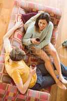 Young couple enjoying red wine on the couch