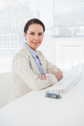 Businesswoman smiling at her desk