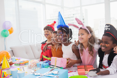 Happy children at fancy dress birthday party