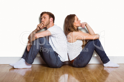 Side view of couple sitting on floor