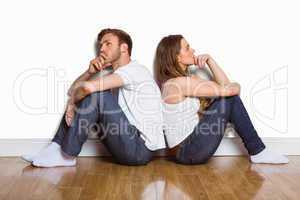Side view of couple sitting on floor