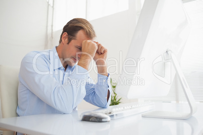 Stressed businessman sitting at his desk