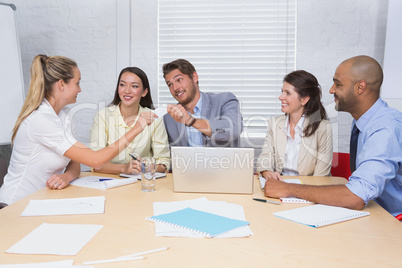 Businesswoman giving a credit card to her colleague