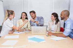 Businesswoman giving a credit card to her colleague