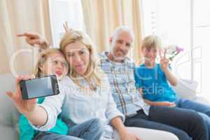 Happy family taking a selfie on couch